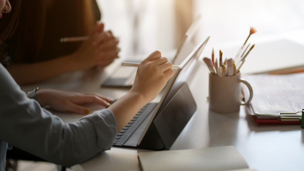 Cropped shot of female professional designer drawing on digital tablet