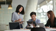 © bongkarn - Group of UI application developer working on their project with positive attitude