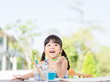 © MIA Studio - Adorable little asian girl holding a paintbrush and working on a painting watercolor for art class in school.Confidence Positivity Freedom Be Creative Concept.