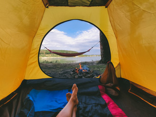 Wall Mural - view form camping tent on campfire with hammock near lake