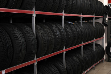 Wall Mural - Car tires on rack in auto store