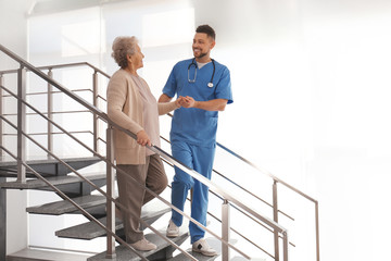 Sticker - Doctor helping senior patient in modern hospital