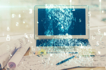 Double exposure of desktop computer and technology theme hologram. Concept of software development.