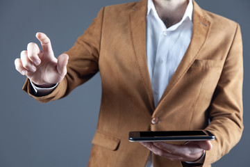 Canvas Print - young business man hand holding  tablet