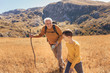 © Mediteraneo - Senior man with grandson on country walk in autumn.