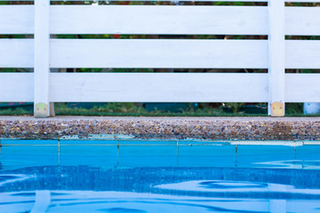 Wall Mural - soft focus concept swimming pool side water surface and garden white wooden deck wall background object outside space for copy or your text here