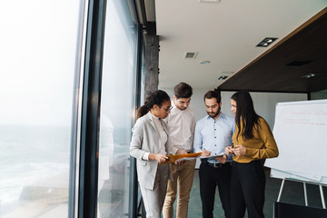 Wall Mural - Portrait of young successful multinational colleagues working in office