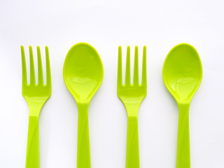 Wall Mural - Green plastic spoon and fork isolated on white background