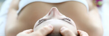 Male Masseur Hand Make Face Massage Young Caucasian Woman Against Spa Cabinet Background Portrait. Beauty Wellness Concept