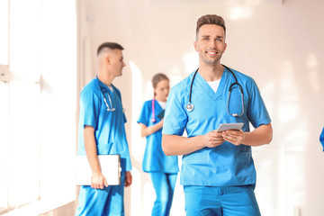 Sticker - Male medical student with tablet computer in hall of clinic