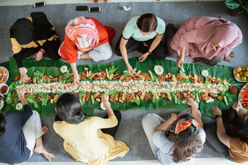 muslim asian woman social gathering at home having lunch together. javanese traditional cuisine