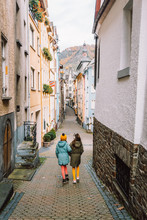 Children Walking In The Streets Of Cochem, Germany, Europe During Winter On A Family Vacation