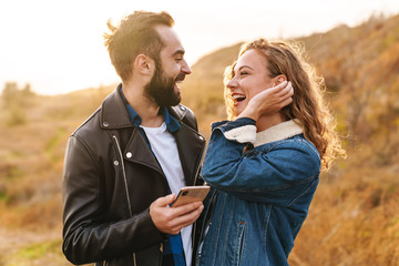 Poster - Beautiful young happy stylish couple wearing jackets