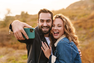 Beautiful young happy stylish couple wearing jackets