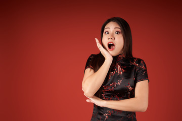 Korean emotional girl on a red background in the studio