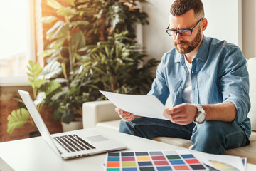 Wall Mural - young   man freelancer working at home on a computer