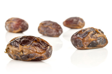 Wall Mural - Group of five whole dry brown date fruit isolated on white background