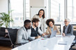 © Sanja - A team of professionals having a meeting in the conference room. They are cheerful and smiling. There are three women and two men.