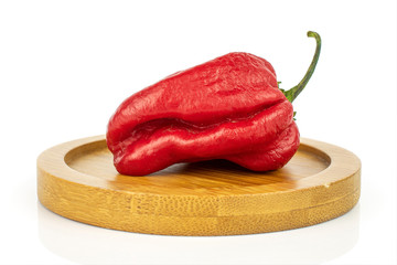 Sticker - One whole hot chili pepper on bamboo coaster isolated on white background