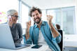 © Sanja - An employee happy to hear the good news about his promotion told by a senior colleague. The female colleague is talking on the phone.