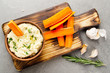 Flat lay view at vegetable Hummus dip dish topped with olive oil served with carrot slices