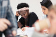 © Sam Edwards/Caia Image - Female community college students reviewing paperwork in classroom