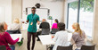 © Chris Ryan/Caia Image - Male community college instructor leading lesson in classroom