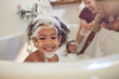 © Trevor Adeline/Caia Image - Portrait cute girl enjoying bubble bath