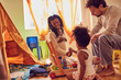 © Trevor Adeline/Caia Image - Pregnant young family playing with toys