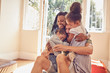 © Trevor Adeline/Caia Image - Happy affectionate young family hugging