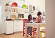 © Trevor Adeline/Caia Image - Mother and daughters at kitchen table