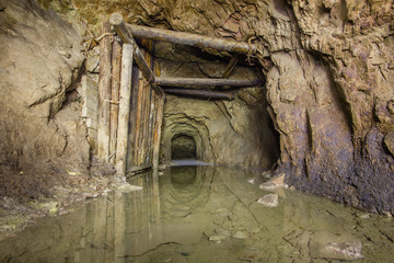 Old copper mine underground tunnel with wooden timbering