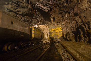 Wall Mural - Gold mine underground tunnel with mining ore carts wagons