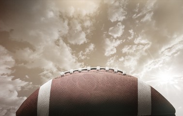 Wall Mural - American football ball on sky background