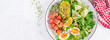 Ketogenic diet breakfast. Salt salmon salad with greens, cucumbers, eggs and avocado. Keto/paleo lunch. Top view, banner