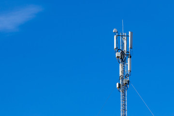 Telecommunications equipment - directional mobile phone antenna dishes on an extension tower. Wireless communication.