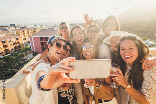 Fotomural Group of happy and cheerful young women have fun in party together outdoor takin