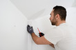 © W PRODUCTION - handsome man worker installing alarm technology insurance in home for burglar prevention