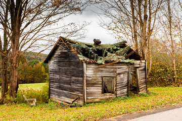 Chair outside of this old collapsing building in a small town in Upstate N