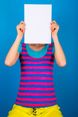 girl with blank white  paper over face, emoticon or identity concept