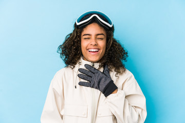 Young african american skier woman isolated laughs out loudly keeping hand on chest.