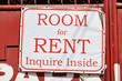 Sign with offered room for rent hanging outside of a red painted old metal gate. Inquire inside is written on the white tarpaulin, Philippines, Asia