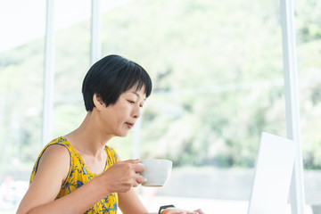 Canvas Print - Asian woman working and using laptop