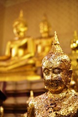 Golden statue of buddha in temple, Thailand	