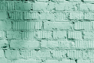 Wall Mural - Painted brick wall close up. Abstract background green color toned