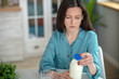 © zinkevych - Young woman looking at the bottle of milk