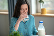© zinkevych - Young woman having a glass of milk in the morning