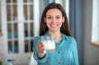 © zinkevych - Smiling young woman drinking milk in the morking
