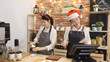 © PRPicturesProduction - happy two asian waitress wearing santa claus hat celebrating christmas event. young girl barista in cute reindeer horns on head making coffee pour into cup. cafe bar staffs working on xmas holidays