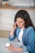 © zinkevych - Woman calling her doctor to get the recommendation about pills